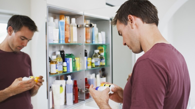 Man in front of medicine cabinet