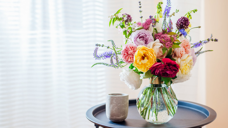 A bouquet of flowers sits in a clear vase.