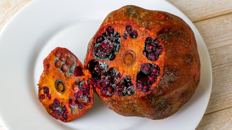 Decaying pomegranate on a plate