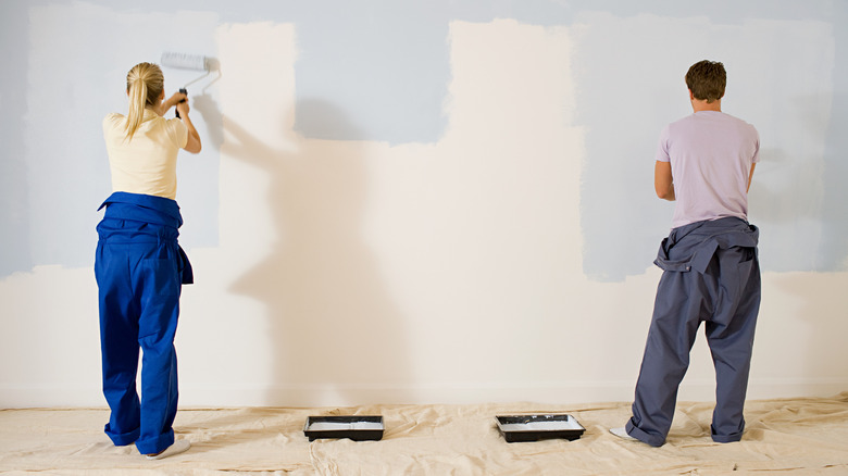 Couple painting wall