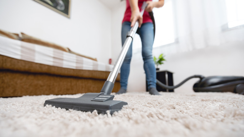 A lady vacuuming 