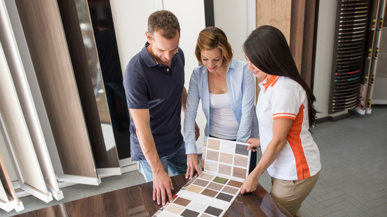 People lookng at different flooring types.