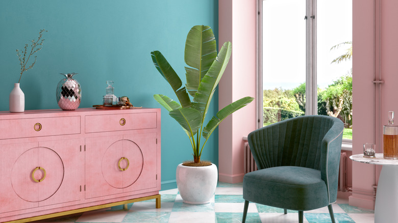 Teal living room with pink sofa