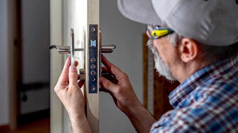 man changing door lock