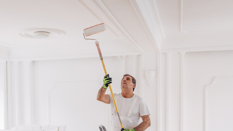 Man painting a ceiling