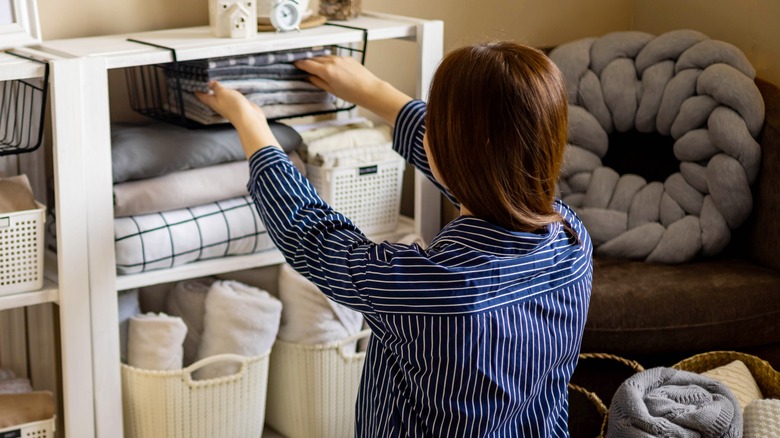 woman organizing home shelves