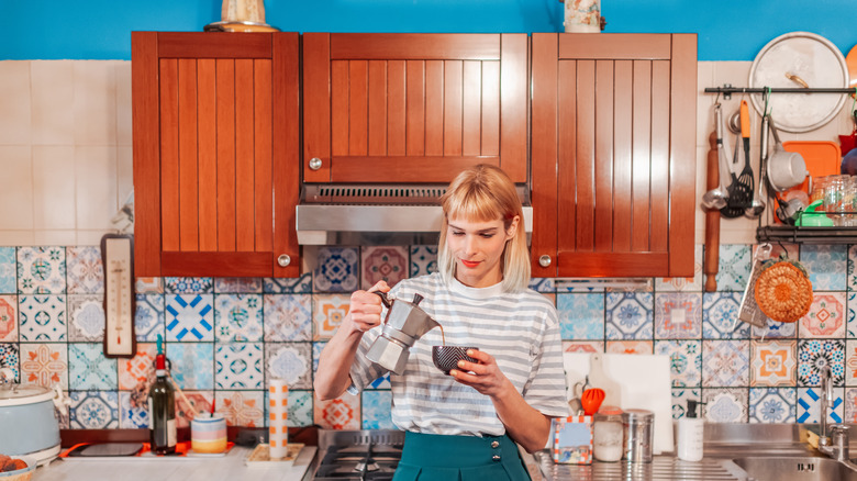 Woman in grandmillennial style kitchen