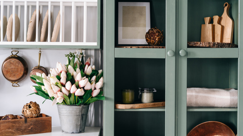 sage cabinet with vintage decor