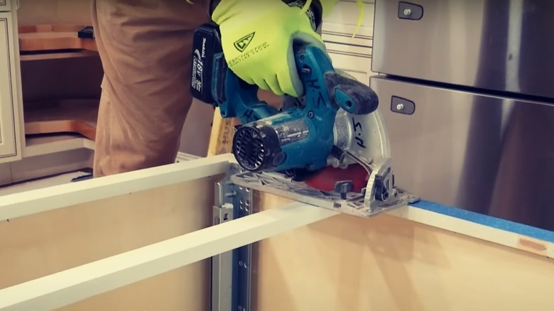 Person removing the brace from kitchen cabinets