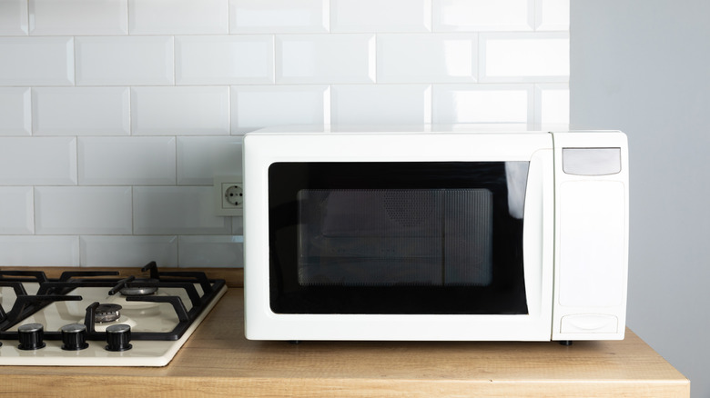 A microwave sitting on a countertop and taking up space