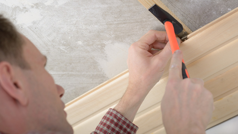 Man installing tongue and groove ceiling