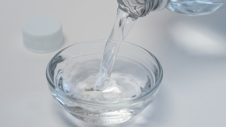 pouring vinegar into bowl