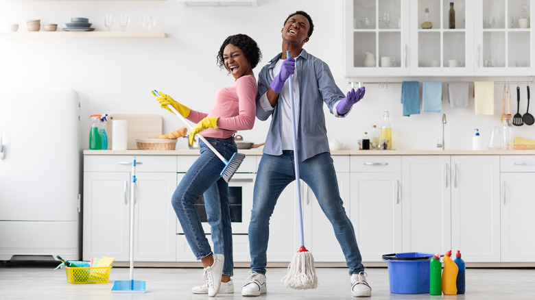 Couple cleaning kitchen 