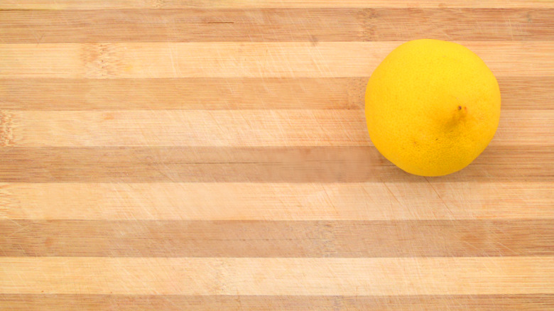 Half of a lemon on a butcher block