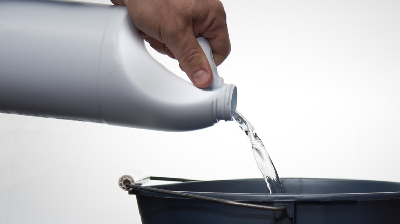 Person pouring bleach