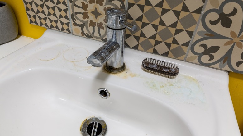 bathroom sink with water stains