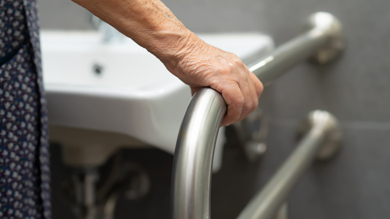 Woman holding safety bar