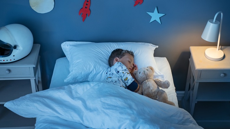 child sleeping with teddy bear