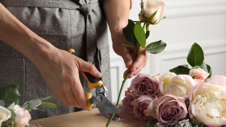 Person cutting flower stems