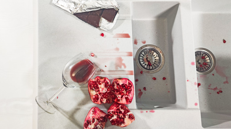 wine, chocolate, pomegranate on kitchen counter