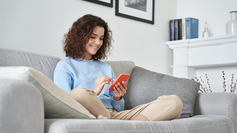 woman scrolling on cell phone