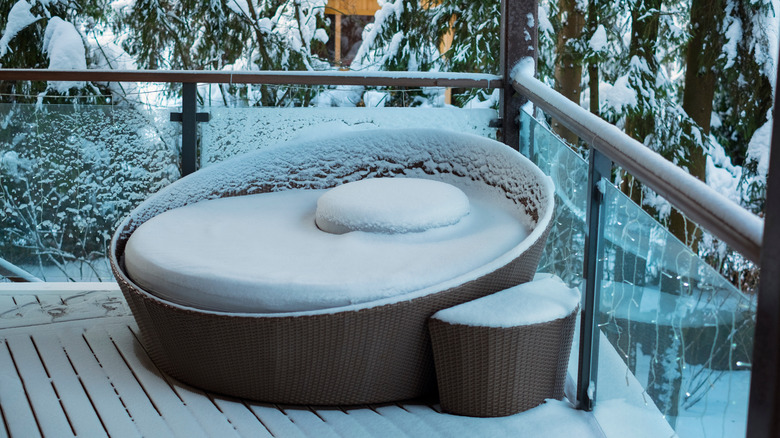 Patio furniture covered with snow