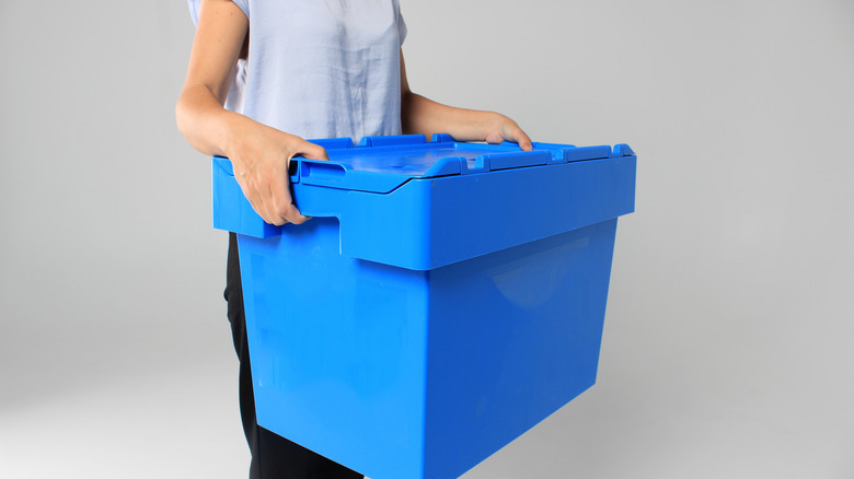 Woman carrying storage container
