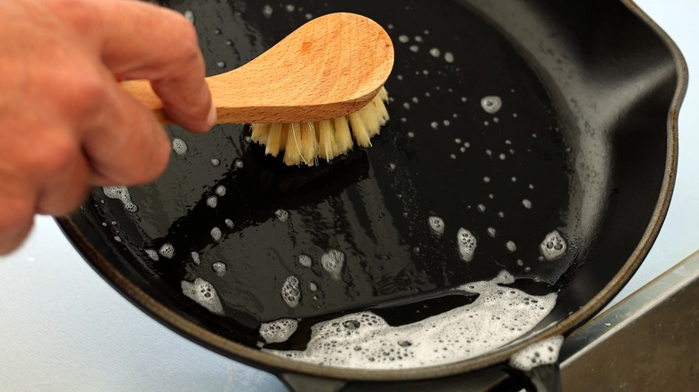 scrub brush cleaning skillet