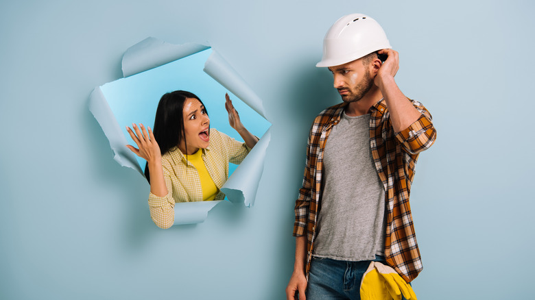 Woman yelling at handyman