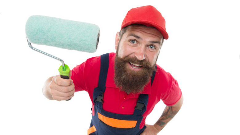 painter holding roller