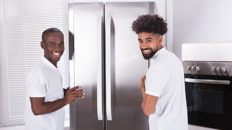 Techs smiling in kitchen