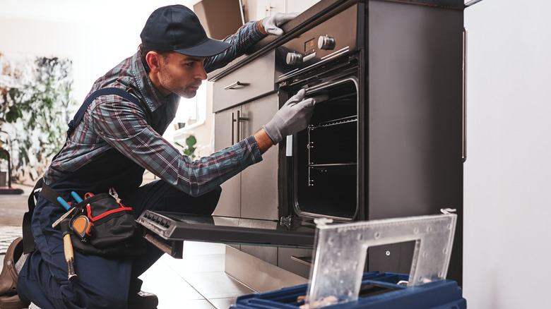 Person repairing oven