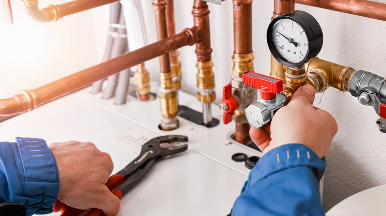 Man checking home water pressure regulator