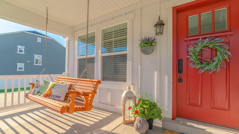 Porch with swing and red door