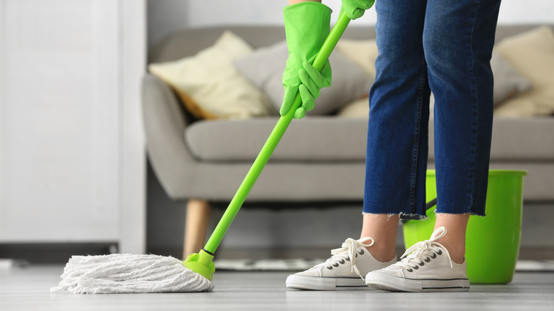 Person cleaning floor with mop