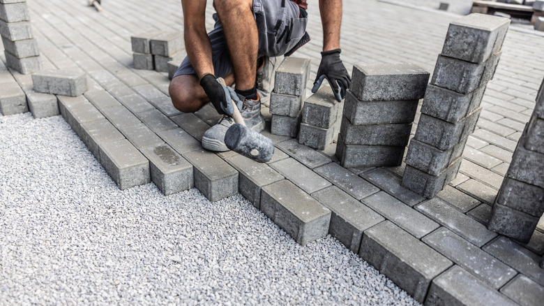 person installing pavers