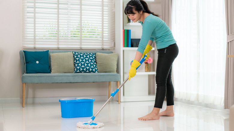 woman cleaning tile floor