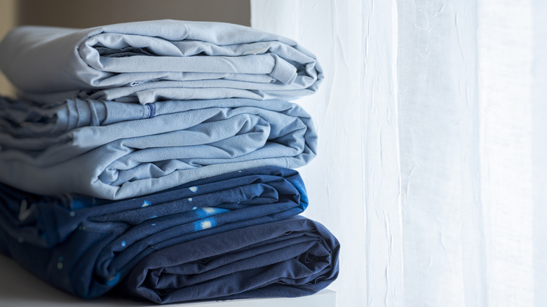 Pile of bedsheets on a ledge