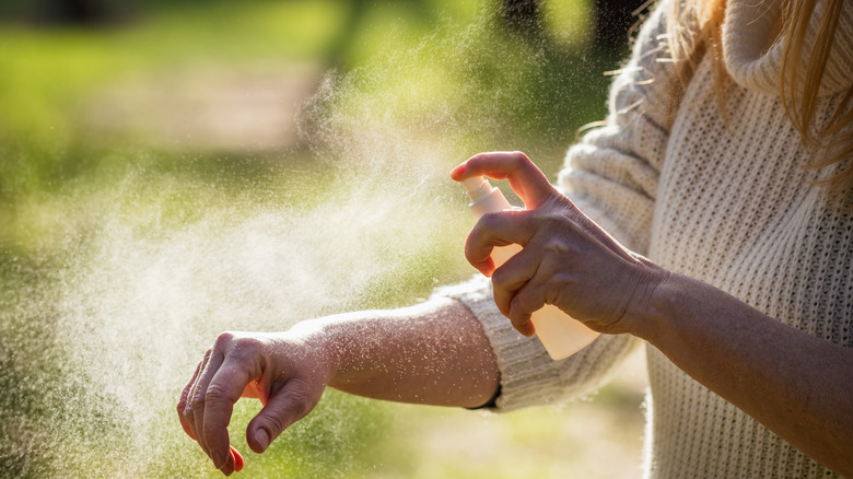 Woman spraying arm