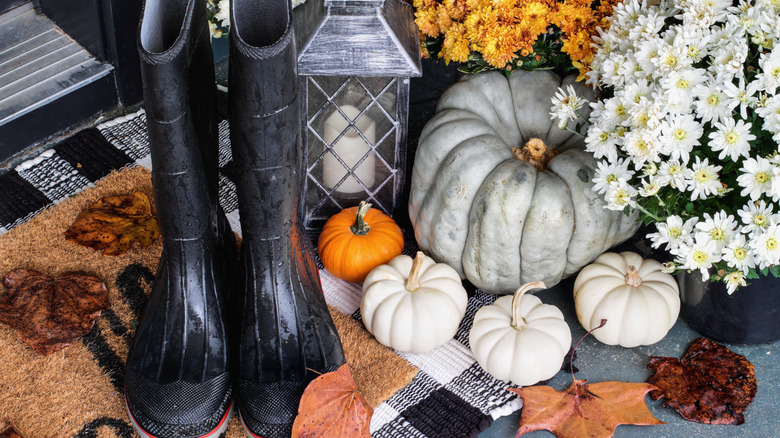 rainboots on fall welcome mat