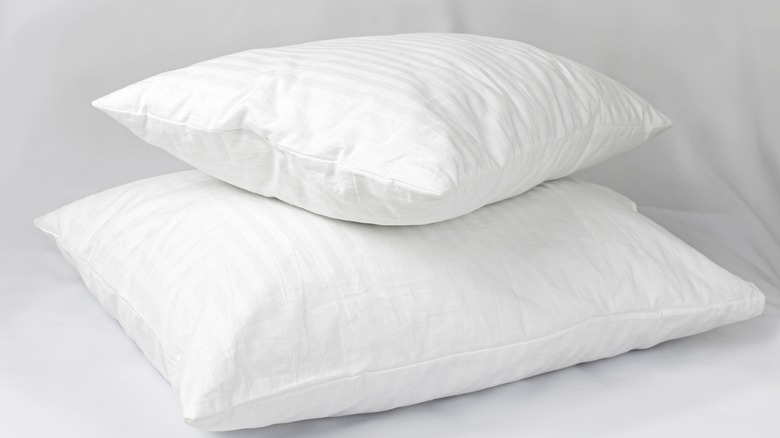 two white pillowcases and pillows