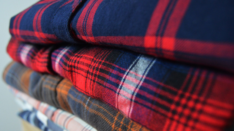 flannel shirts stacked in pile