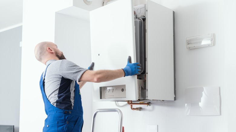 plumber looking at boiler