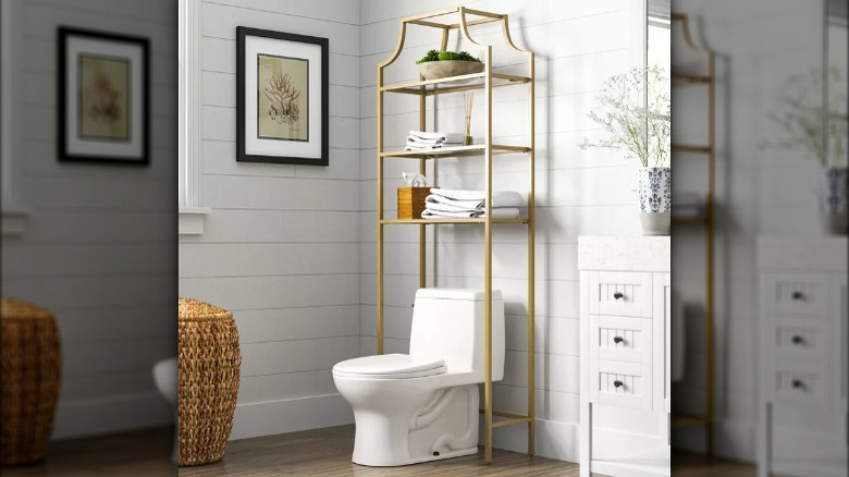 shelving unit above a toilet