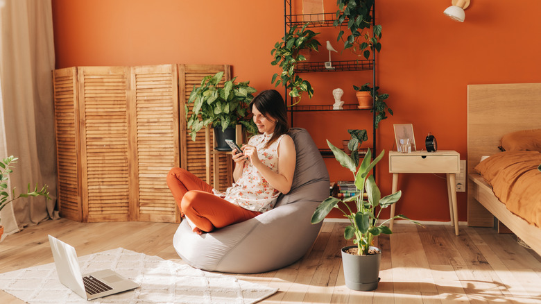 woman lounges in rustic room