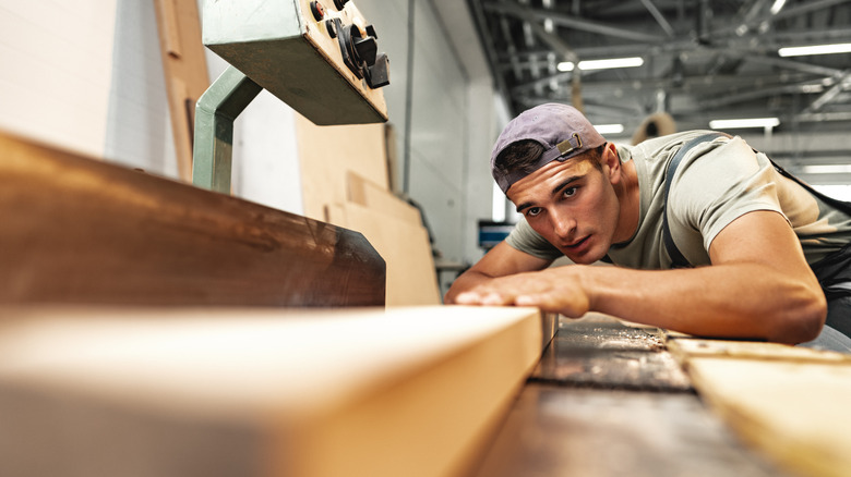 Someone working with a piece of wood for a DIY project