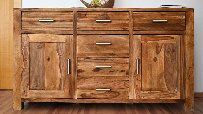 A wood buffet with metal handles