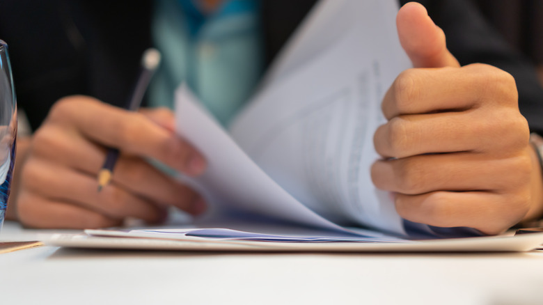 person looking over paperwork