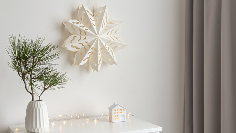 Paper snowflake hanging from wall 