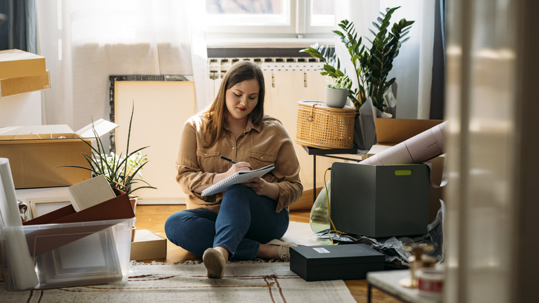 woman organizing items to donate